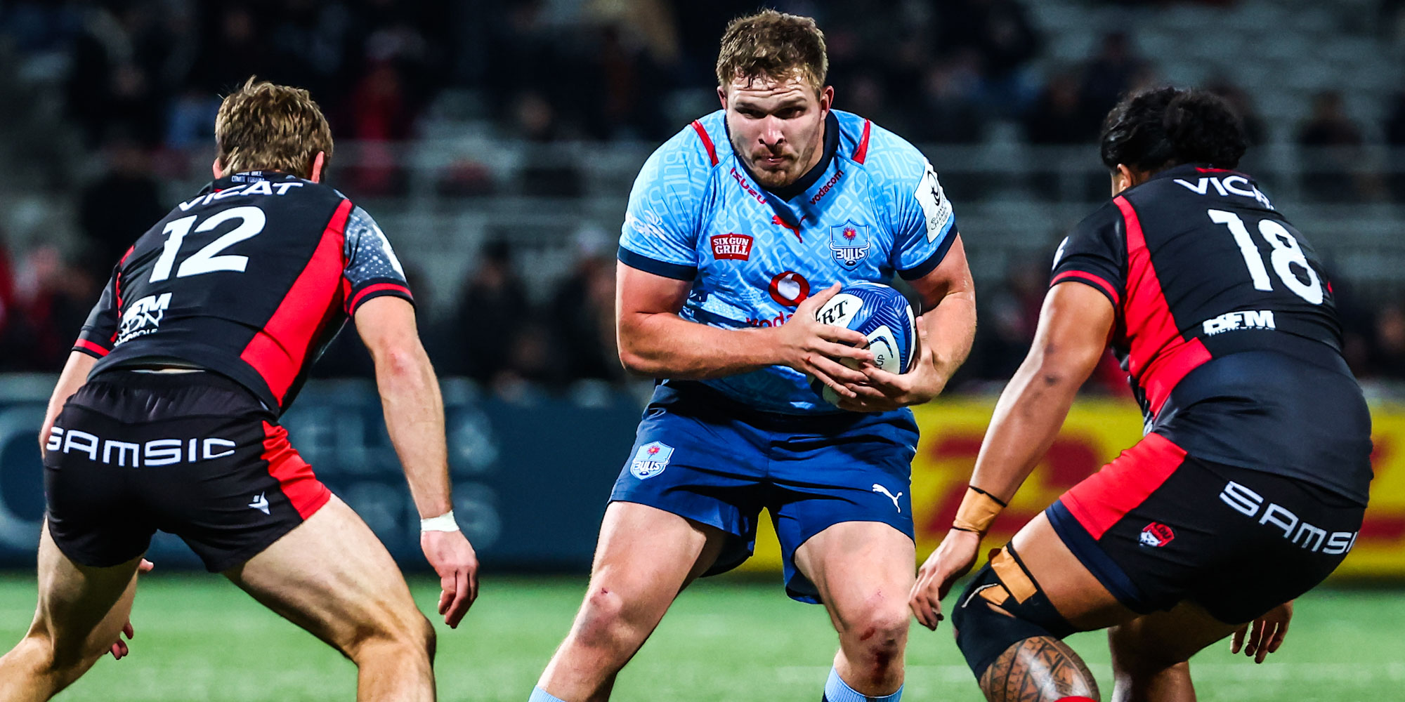 Two players from Lyon look to stop the Vodacom Bulls' Jan-Hendrik Wessels.